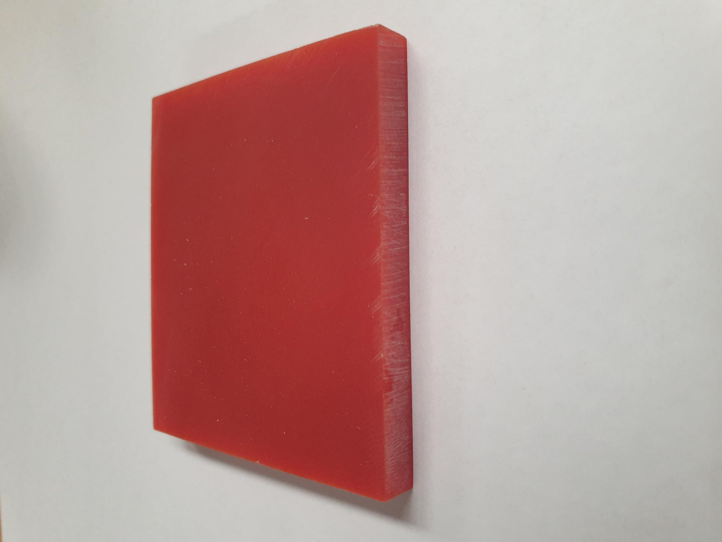 <p>Red stone reconstituted stone blanks 60 x 70 x 7mm suitable for inlay. Can be cut with standard cutting tools - jewellery saw similar in characteristics to mother of pearl (hardness approx. 3. Can be sanded and polished same way as shell material.</p>