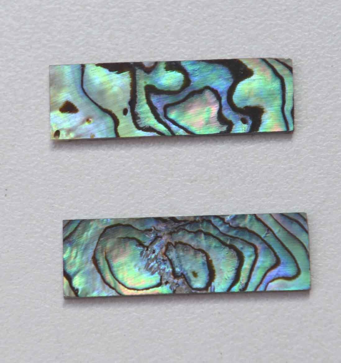 <p>Paua abalone (New Zealand Paua shell) flat inlay blanks size 9mm (0.35") width x 29mm (1.14") length x 1mm (0.04") thickness B grade good on at least 1 side may have some worm damage or shell skin on edges of reverse side.</p>