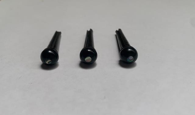 1 set (6pcs) Guitar bridge pins  size 2A ebony with paua dot. Tapered shaft string slot running the full length of shaft. Diameter at top of shaft 5.6mm (0.22") length of shaft 25.5mm (1") . Will fit the following models - Martin guitars since 1994,as well as D-28 older Gibson guitars,and others.