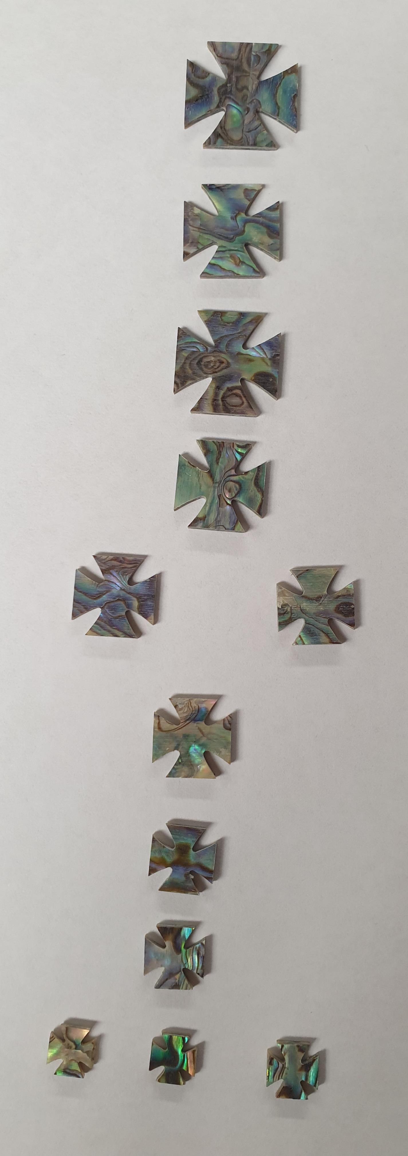 <p>A set of 12pcs Paua abalone Iron cross inlays. Suitable fingerboard inlay. Shell thickness 1.5mm. Flat and ready to be installed.</p>