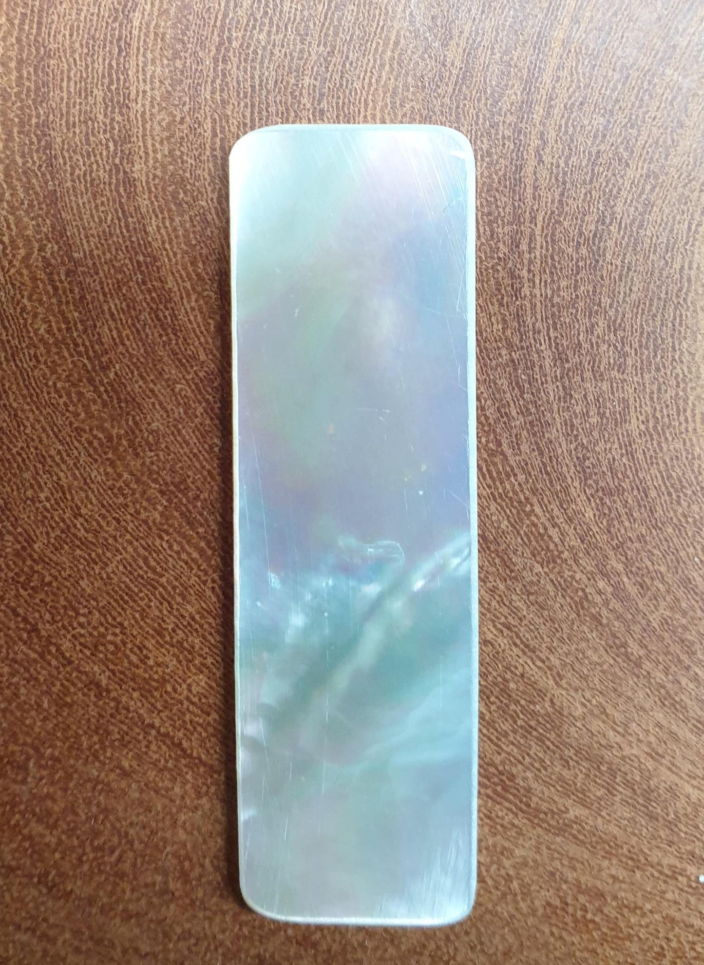 <p>White Mother of Pearl flat inlay blanks with rounded edges, size 15mm (0.6") width x 50mm (2") length x 1.5mm (0.06") thickness polished 1 side A grade good on both sides.</p>