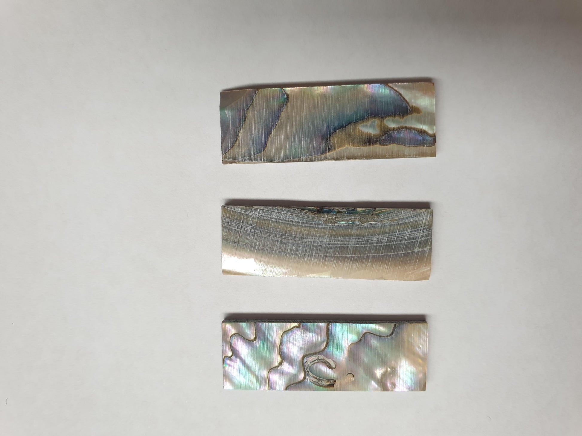 <p>Green abalone (Mexican green abalone) flat inlay blanks size 12mm (0.47") width x 35mm (1.38") length x 2mm (0.079") thickness B grade good on at least 1 side - may have some shell skin or worm damage on 1 side.</p>