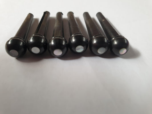 1 set (6pcs) Guitar bridge pins  size 2A Ebony with White Mother of Pearl dot Tapered shaft string slot running the full length of shaft. Diameter at top of shaft 5.6mm (0.22") length of shaft 25.5mm (1") . Will fit the following models - Martin guitars since 1994,as well as D-28 older Gibson guitars,and others.