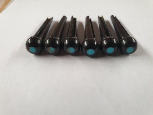 1 set (6pcs) Guitar bridge pins  size 2A Ebony with Turquoise dot Tapered shaft string slot running the full length of shaft. Diameter at top of shaft 5.6mm (0.22") length of shaft 25.5mm (1") . Will fit the following models - Martin guitars since 1994,as well as D-28 older Gibson guitars,and others.