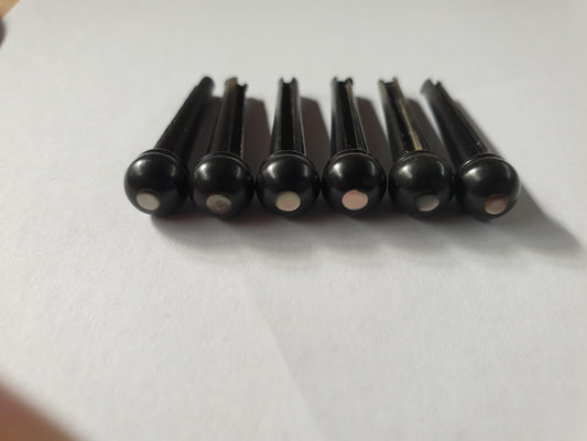 1 set (6pcs) Guitar bridge pins size 2A Ebony with Black MOP dot. Tapered shaft string slot running the full length of shaft. Diameter at top of shaft 5.6mm (0.22") length of shaft 25.5mm (1") . Will fit the following models - Martin guitars since 1994,as well as D-28 older Gibson guitars,and others.