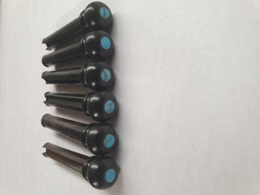 1 set (6pcs) Guitar bridge pins  size 1 Ebony with Turquoise dot Tapered shaft string slot running the full length of shaft. Diameter at top of shaft 5.3mm (0.21") length of shaft 22.9mm (0.9") . Will fit the following models - Martin guitars prior to 1994 (except HD-28), Collings guitars, prior to 2002, Blanchard, Garrison, Goodall, Ryan, Santa Cruz, Taylor, Larrivee D-03R and others.