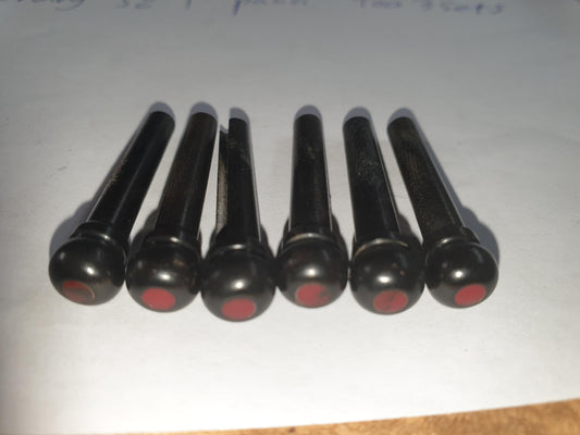 1 set (6pcs) Guitar bridge pins  size 1 Ebony with Bloody Jasper dot Tapered shaft string slot running the full length of shaft. Diameter at top of shaft 5.3mm (0.21") length of shaft 22.9mm (0.9") . Will fit the following models - Martin guitars prior to 1994 (except HD-28), Collings guitars, prior to 2002, Blanchard, Garrison, Goodall, Ryan, Santa Cruz, Taylor, Larrivee D-03R and others.