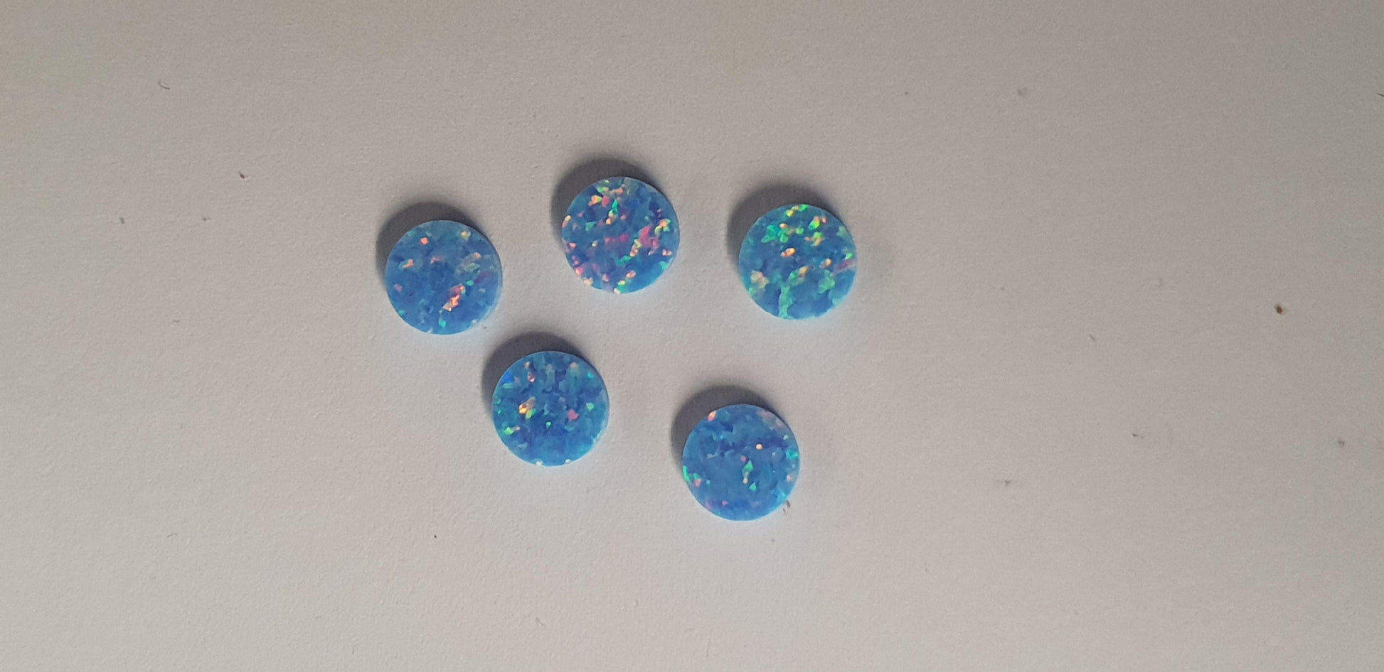 Opal dots OP74 7 x 1.3mm flat pcs made to specific diameter and thickness made from manufactured opal suitable for inlay, fretboard markers, jewellery, Opal dots can be worked same way as mother of pearl and are of similar hardness..