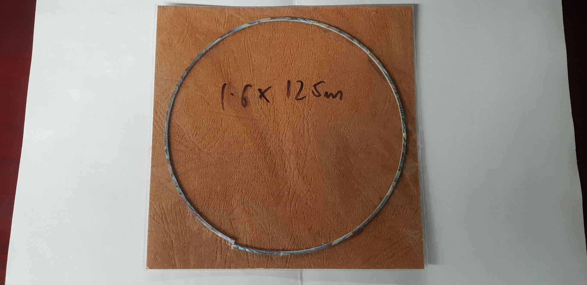 Paua abalone solid shell curved strips rosette set 1.6mm (0.063") width x 1.3mm (0.05") thickness x 125mm (4.92") inside diameter. A grade quality good on both sides, flat and uniform in thickness and width. Ideal for use in purfling and rosettes on musical instruments - Ukuleles, guitars, mandolins etc. as well as in furniture, jewellery and other decorative applications.