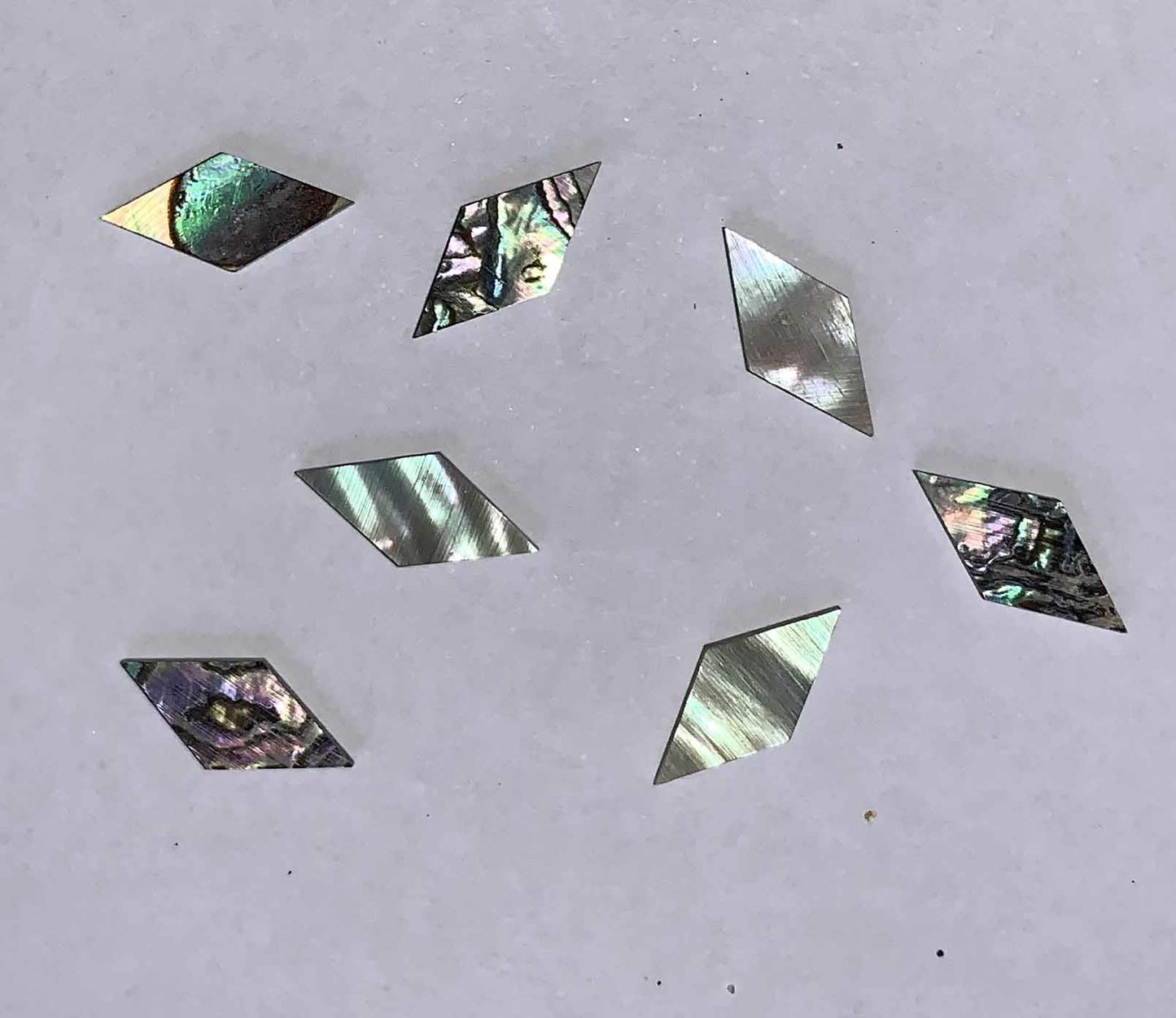 Green abalone (Mexican green abalone) diamonds size 6.7mm width x 13.3mm length x 1.5mm thickness. Some uses include fretboard markers, musical instrument inlay, furniture inlay, marquetry, pool cue inlay and other general decorative inlay and jewellery applications. All pcs are A grade.