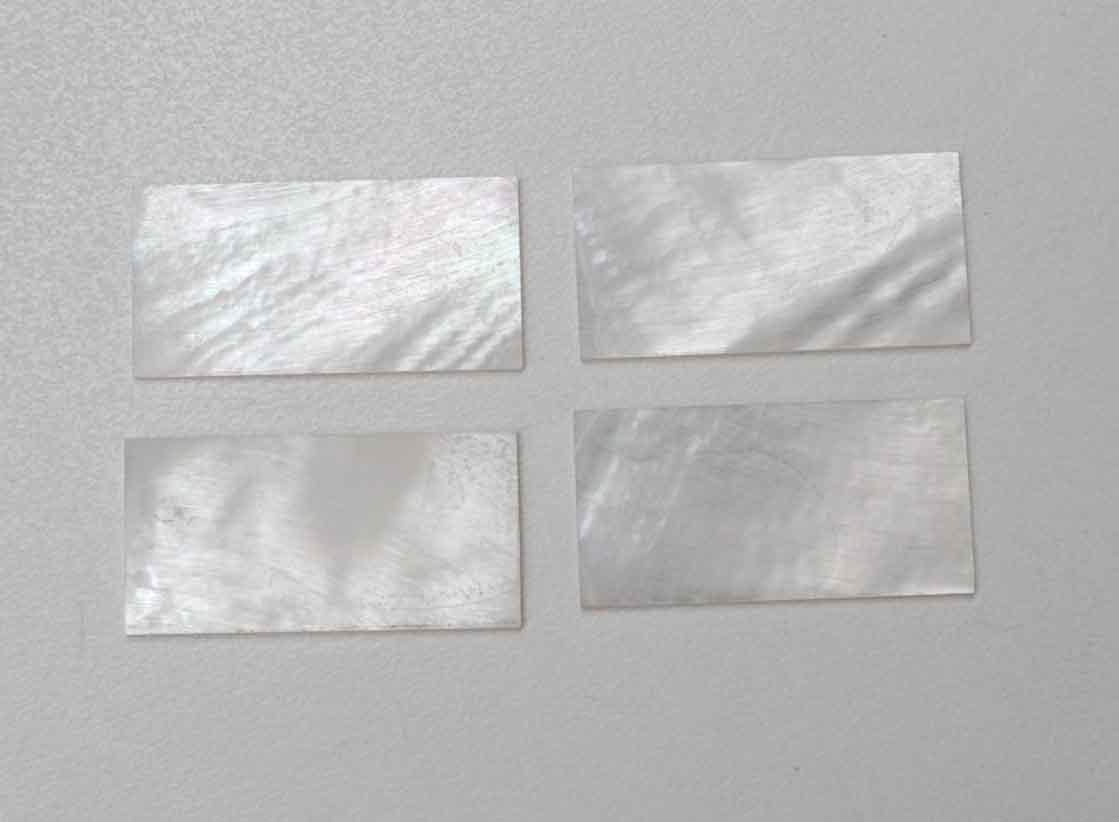 <p>White Mother of Pearl flat inlay blanks size 30mm (1.18") width x 50mm (1.97") length x 0.9mm (0.0354") thickness A grade good on both sides.</p>