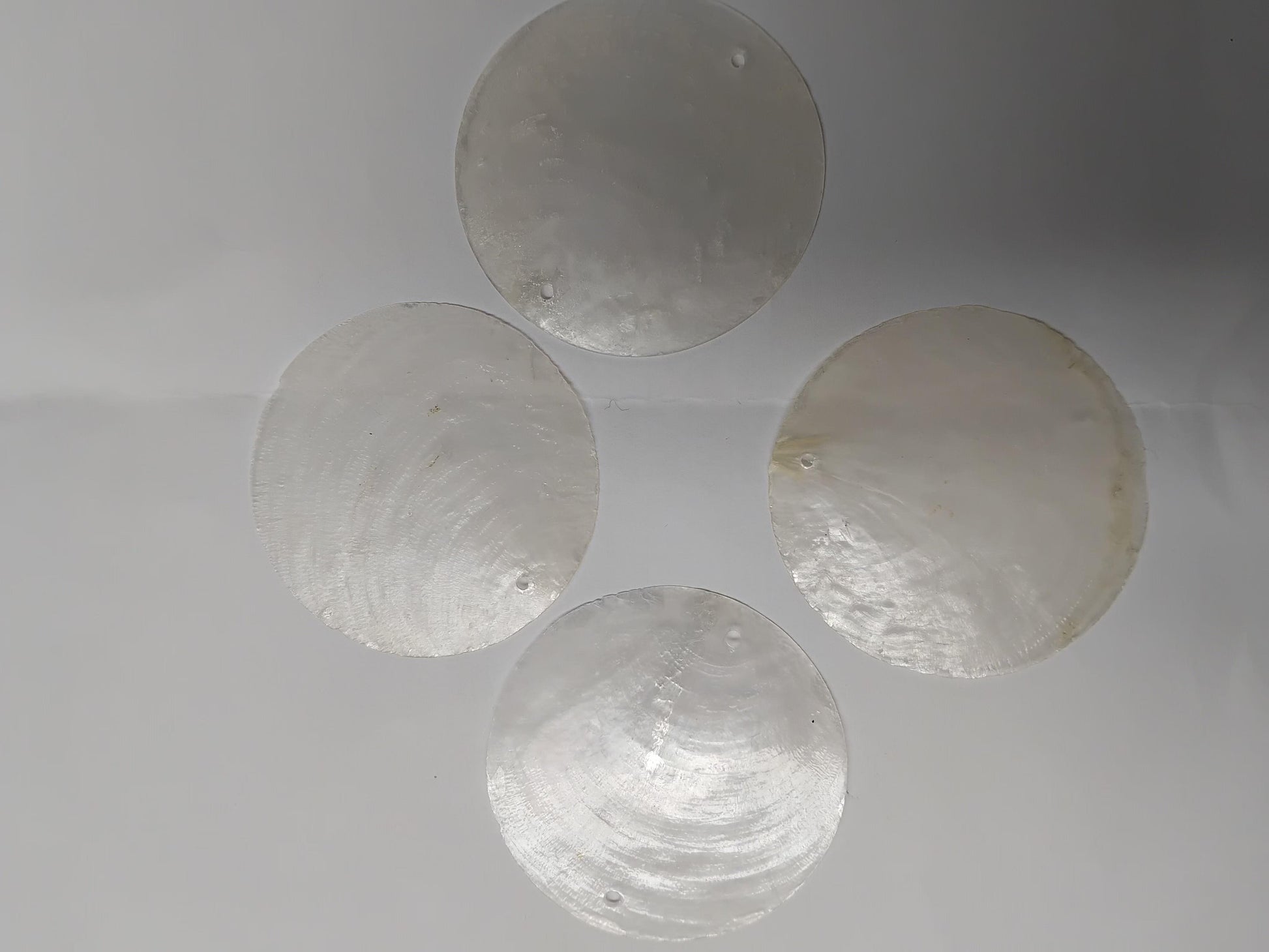  Capiz shell discs round Capiz shell discs with hole can be used as hanging ornaments furniture decorations, jewellery.